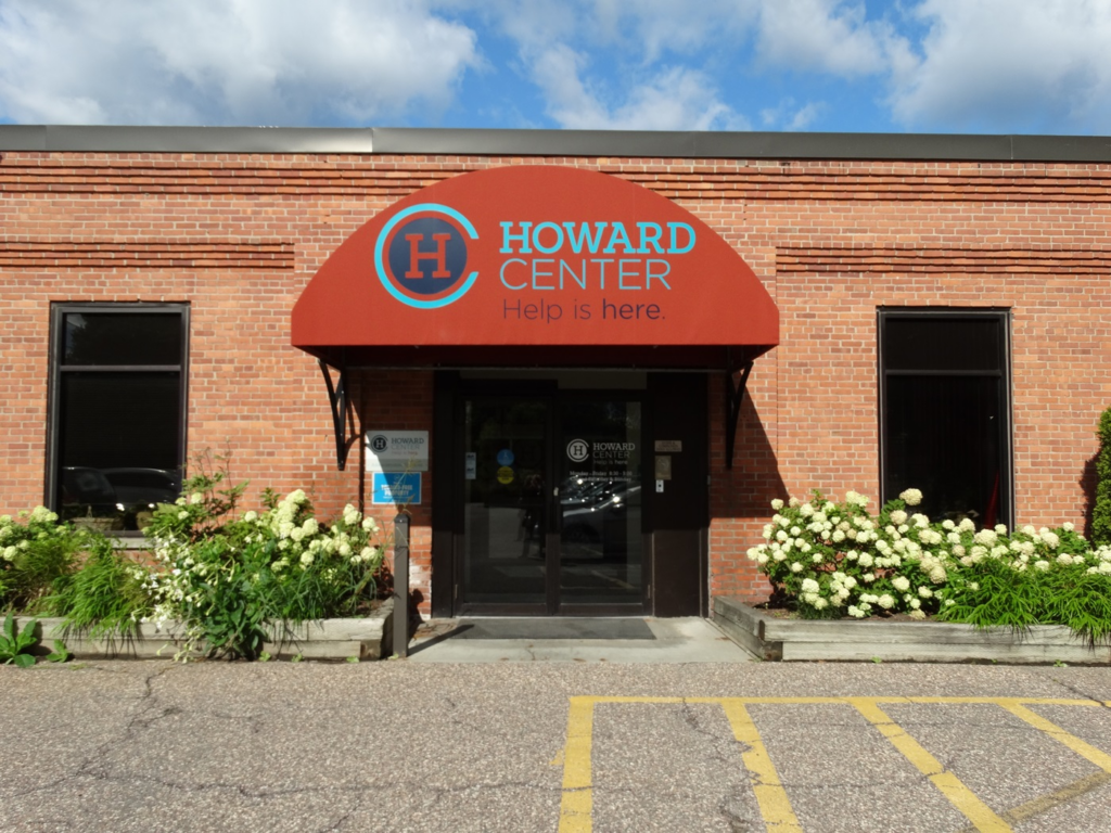 brick one-story building with signage that reads "howard center help is here."